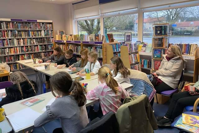 Children engrossed at the session with author Loretta Schauer.