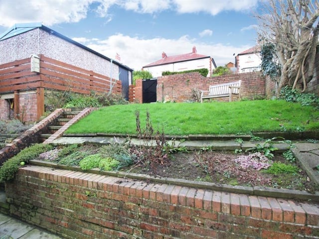 A lawned garden with planted areas.