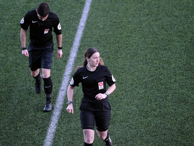 Match officials exit the Flamingo Land Stadium pitch at the start of the second-half suspension.