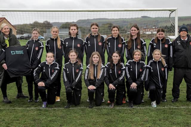Beyond Housing Community Connector Coordinator Stephanie Lake (left) presents the new Beyond Housing sponsored strip to the Scarborough Ladies U14 team, with their Manager Colin Hepples (right).