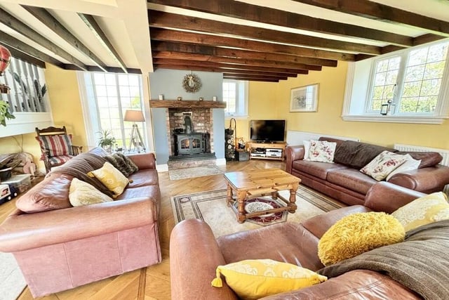 A light, spacious but cosy sitting room, with central feature fireplace and warming stove.