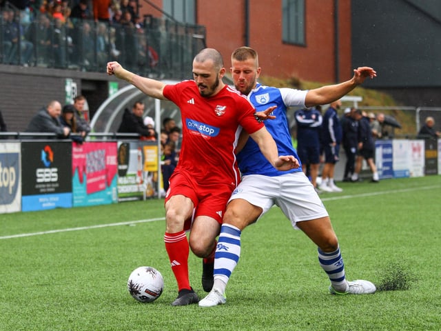 Frank Mulhern holds off a Tonbridge player