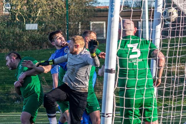 Jay Jordan heads home his second goal for Fishermen against Slingsby. Photo by Brian Murfield