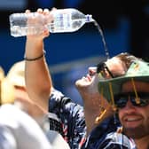 A spectator attempts to cool down in the heat. Photo: Quinn Rooney/Getty Images