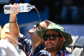 A spectator attempts to cool down in the heat. Photo: Quinn Rooney/Getty Images
