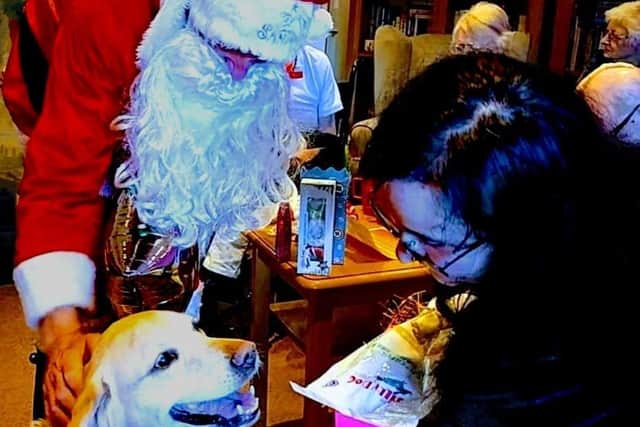 Olive celebrating her retirement with Santa Claus