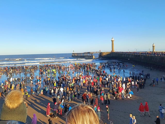 Boxing Day dippers on the beach, as seen as Battery Parade.
