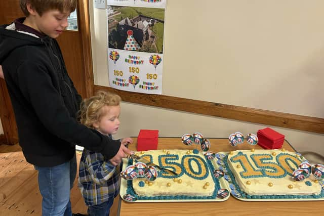 Egton School's 150th cake was cut by James (year six) and Parker (reception), the oldest and the youngest pupils in the school.