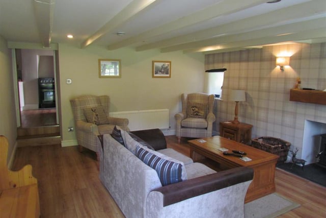 The spacious, beamed sitting room within the cottage.