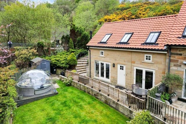 An exterior view of the end terrace cottage and garden on the Raithwaite Estate.
