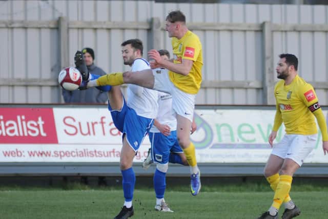 Town's Lewis Dennison battles for the ball against Tadcaster