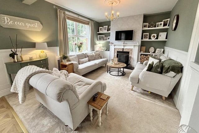 A light and spacious lounge has a real fire within a feature fireplace.