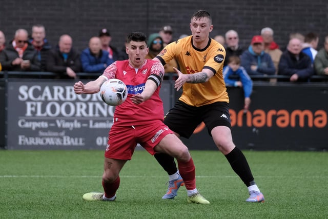 Scarborough skipper Michael Coulson holds off a Southport rival.