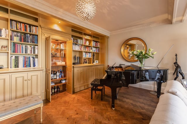 The drawing room has bespoke cabinetry that conceals a bar.