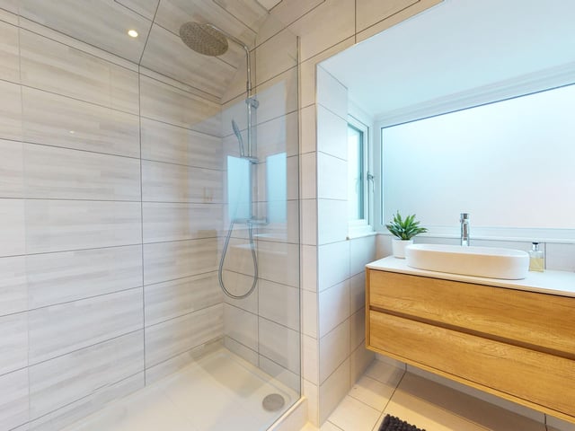 A walk-in double shower is a feature of this modern facility.