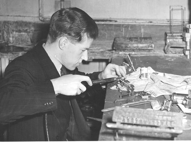 Dennis Raper working on his electronics hobby in the 1940s.