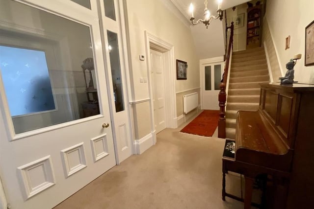A welcoming hallway with staircases up and down leads to the ground floor rooms including a utility room and w.c..