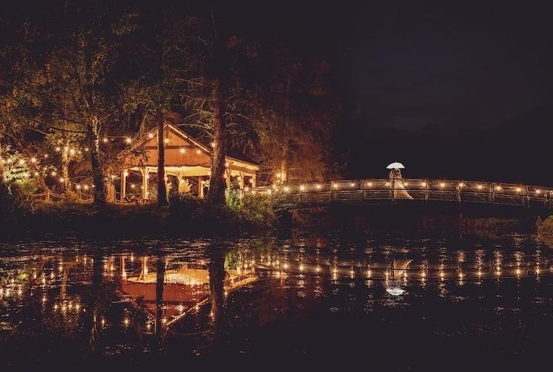 The wedding venue lit up at night.