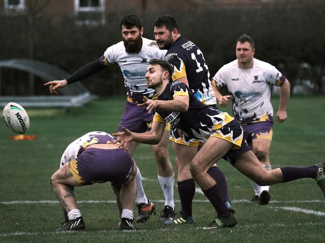An Old Boys player passes it on