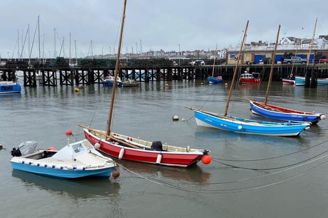 A calm harbour is framed by Ian Sandy.