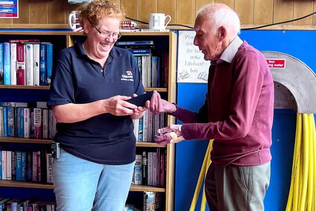 Neil Anderson, chairman of Staithes and Runswick RNLI lifeboat, presents volunteer crew member Liz Wilson with her 20 year service medal.picture: RNLI/James Stoker