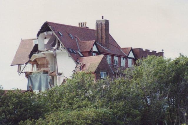 Ruins of the hotel stand out above the trees.