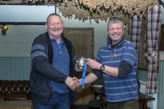 Peter Horbury receives the tankard from Mark Stonehouse.