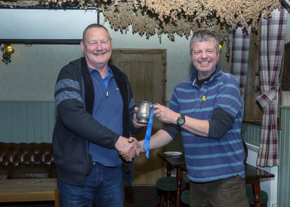 Peter Horbury receives the tankard from Mark Stonehouse.