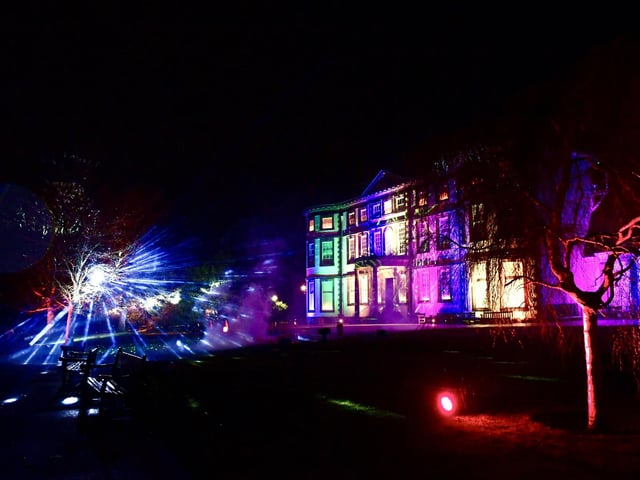 The lights cast onto the historic house are colourful and dramatic.