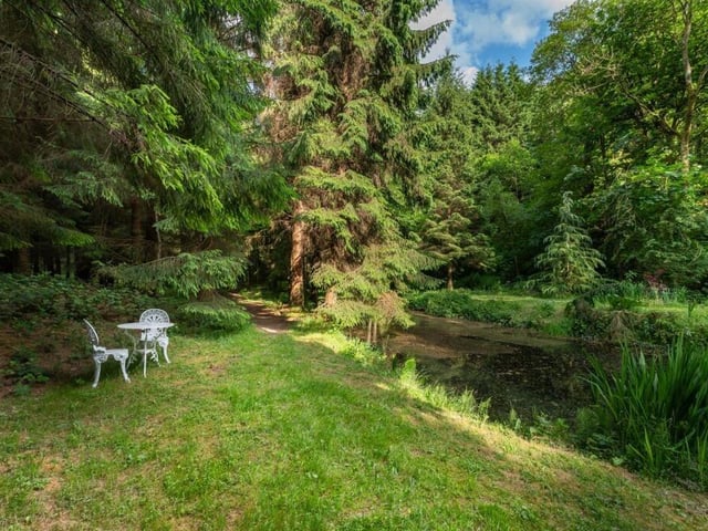 Grassy banks, woodland walks and picturesque streams are all part of the scenic grounds.