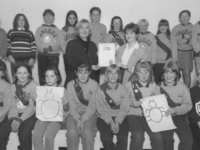 Northstead Methodist Guides guider Petra Jackson receives the certificate from Stephen Joseph Theatre Appeal Trust coordinator Wendy Saunders in November 1995, watched by the guides who raised £25 towards the appeal by holding a beetle drive. 