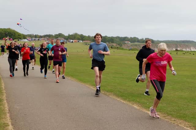 Bridlington Road Runners' Patricia Bielby (pink top) leads this group at the Sewerby parkrun. Photo by Kirsty Dew (TCF Photography)