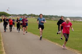 Bridlington Road Runners' Patricia Bielby (pink top) leads this group at the Sewerby parkrun. Photo by Kirsty Dew (TCF Photography)