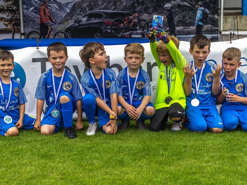 Proud young footballers with their medals. photo: Brian Murfield