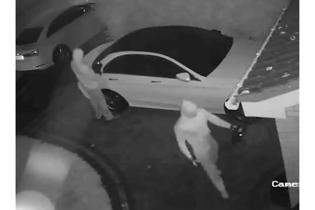 This CCTV image from West Midlands Police shows relay thieves in action