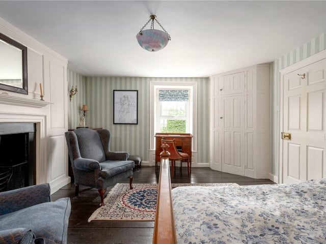 Another stylish double bedroom with a fireplace and panelled surround.