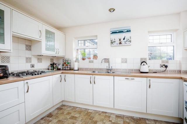 The kitchen has fitted units, with an integrated double oven, gas hob and dishwasher.