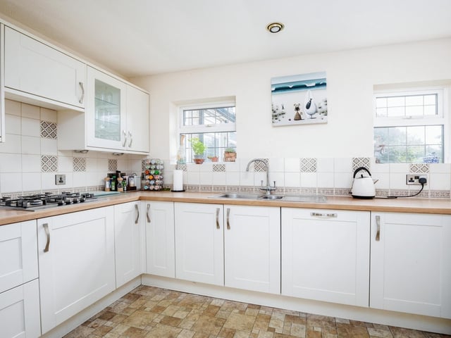 The kitchen has fitted units, with an integrated double oven, gas hob and dishwasher.