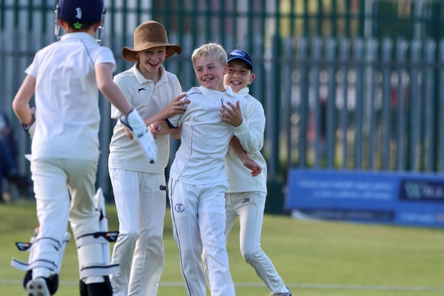 The Brid players congratulate the bowler.