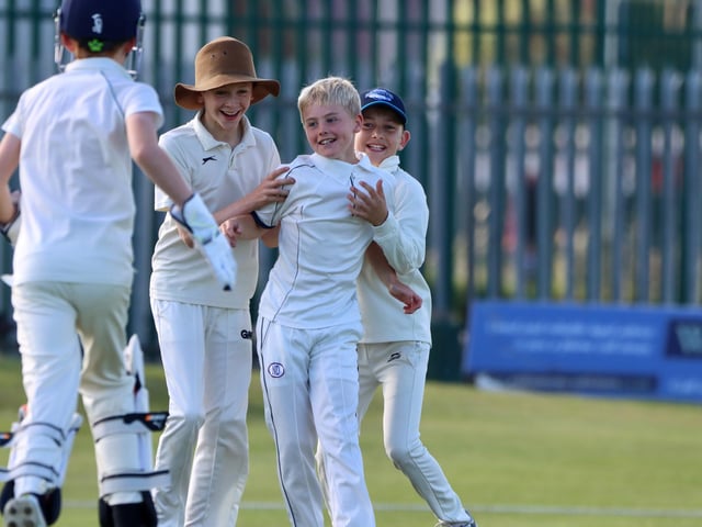 The Brid players congratulate the bowler.