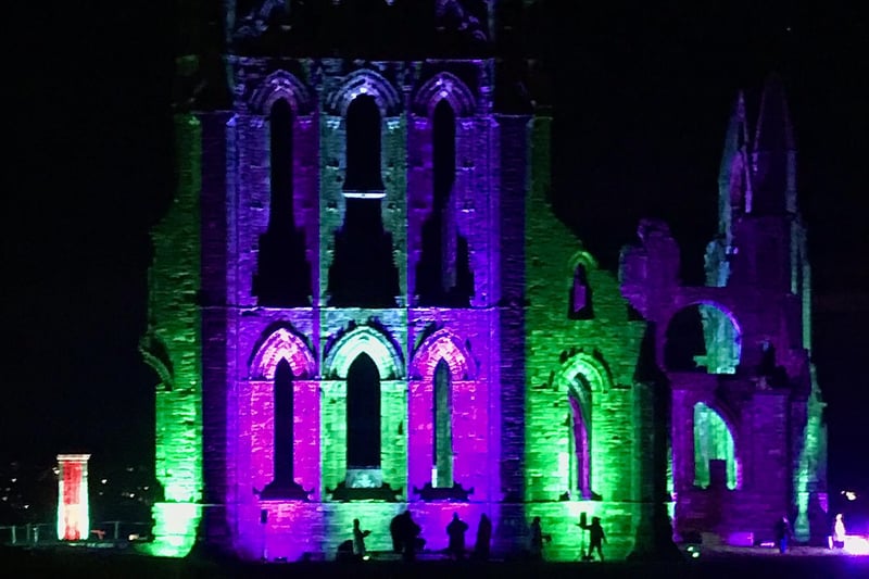 Silhouettes of people watching the colour changes on the abbey walls.
picture: Anthony Holmes