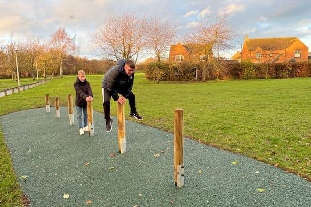 Two youngsters give the new trim trail a go.
