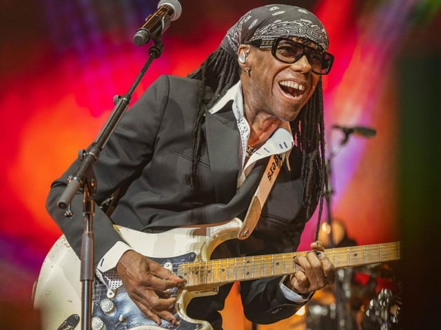 The iconic Nile Rodgers jams out on stage.