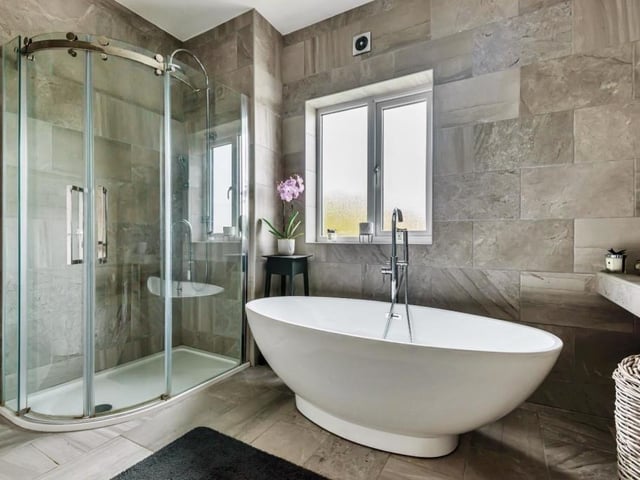 This luxurious bathroom has underfloor heating.