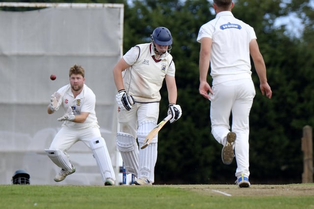 Seamer batter Archie Graham misses out while Flixton keeper Will Norman looks to pouch the ball