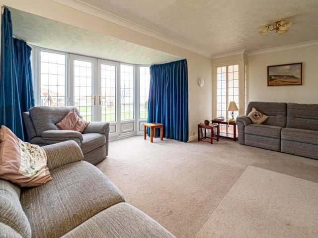 The spacious lounge has French doors leading outside.