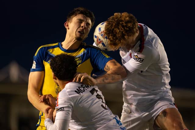 Boro man of the match Jake Hull battles it for a header at AFC Fylde. Photo by Wandering Photography