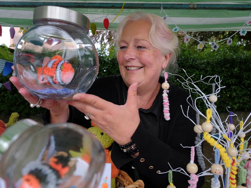 Babs Binder with her cuddly fish in a jar for sale.