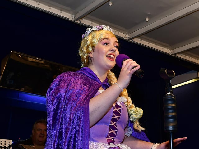 Singing on stage from the YMCA Panto Princess