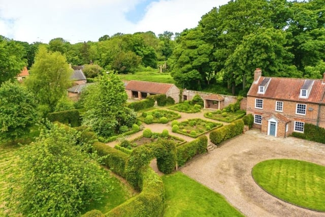 The listed building's grounds include numerous outbuildings that present potential for various uses.